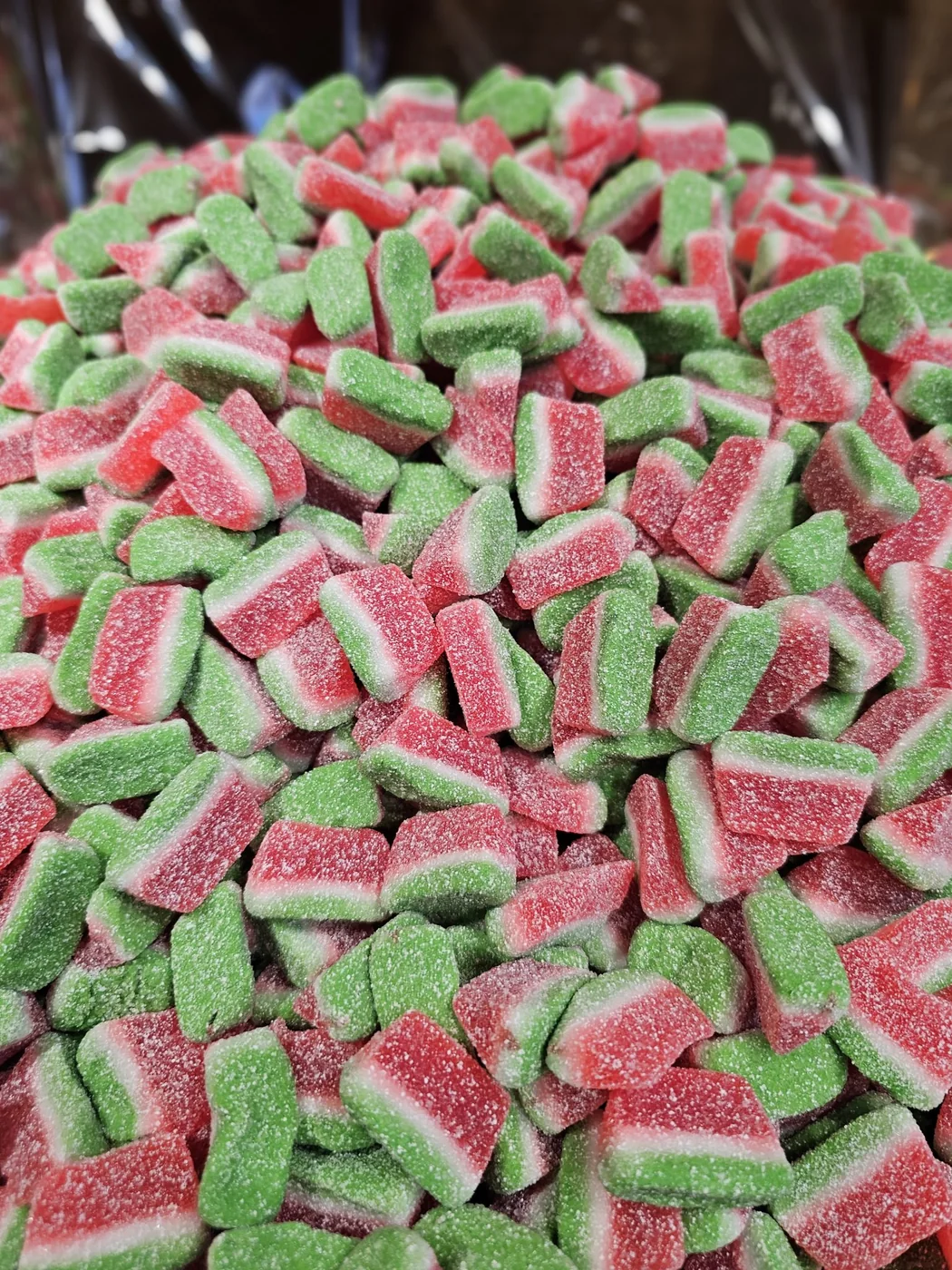 A pile of red and green watermelon-shaped gummy candy