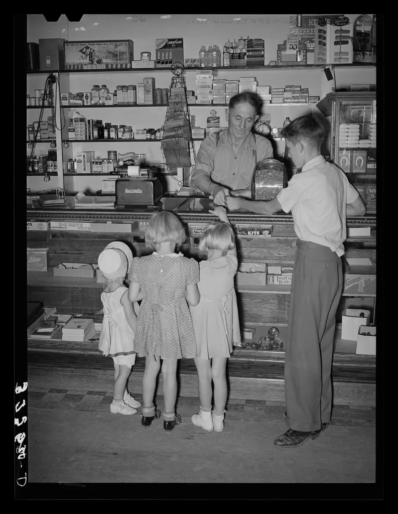 Historic black-and-white scene of children buying candy at a store