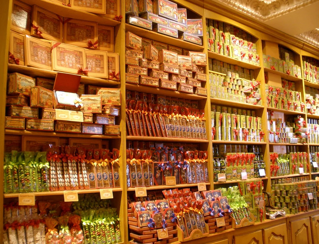 Shelves filled with jars and bins of sweets in a candy shop