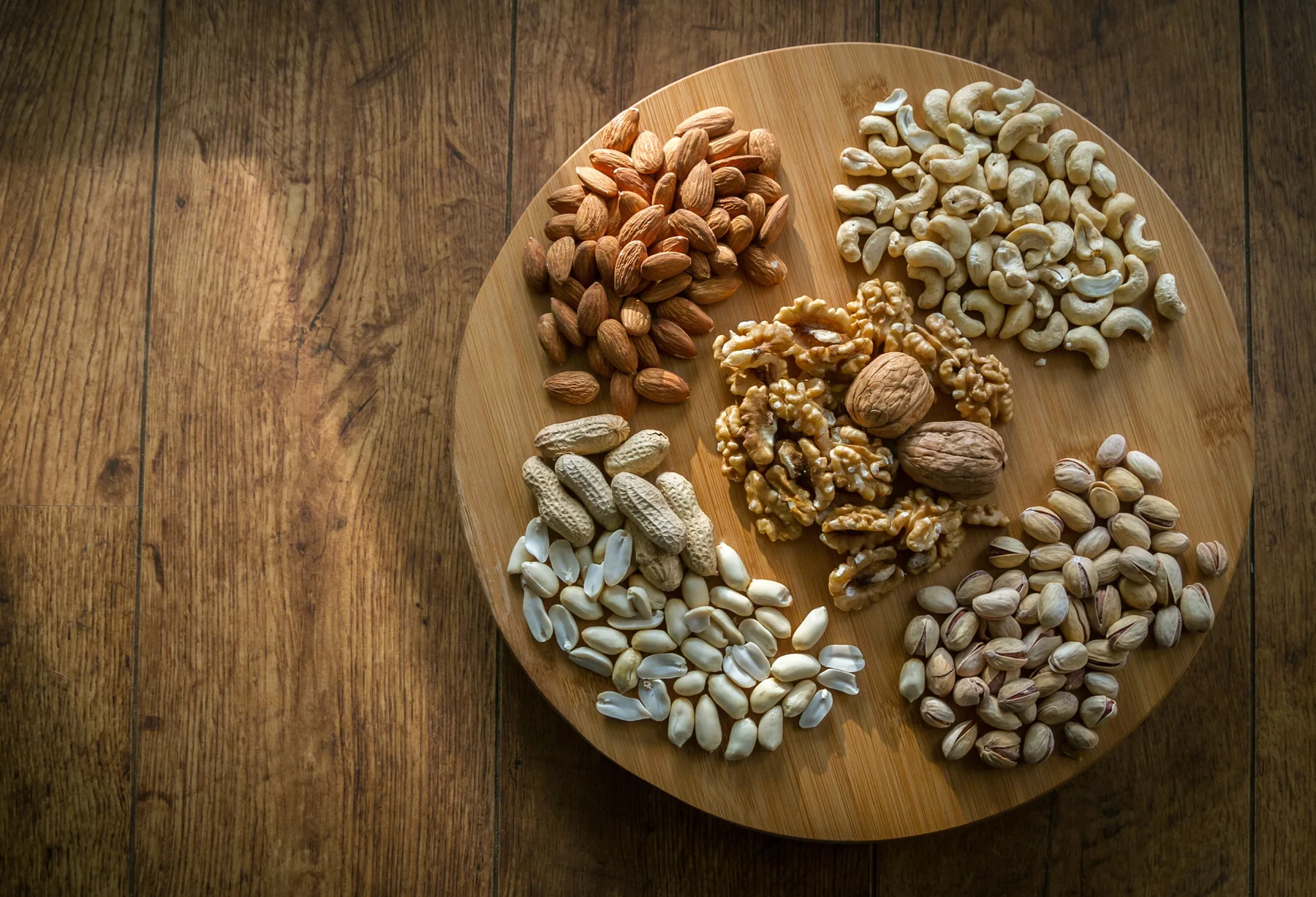 Walnuts, pistachios, cashews, and almonds arranged together