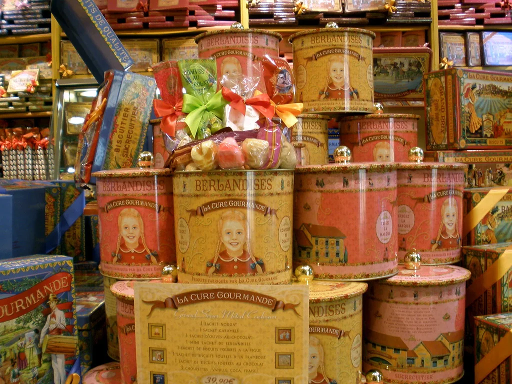 Jars and boxes of sweets stacked on a market shelf