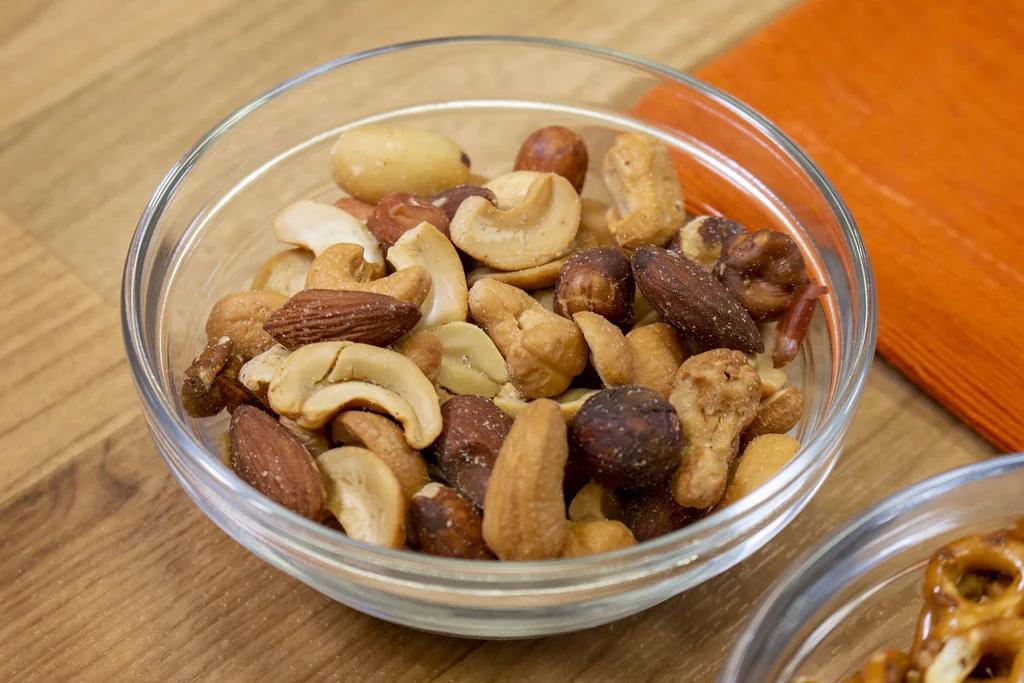 A small bowl filled with a mix of roasted nuts