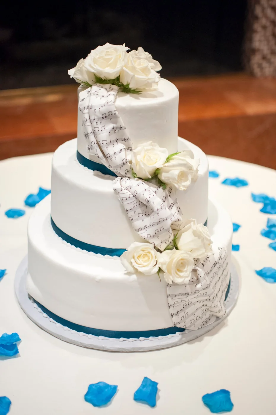 A tiered wedding cake decorated with white and pink flowers